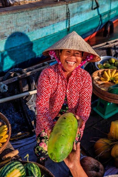 Vietnamese woman selling fruits on floating market