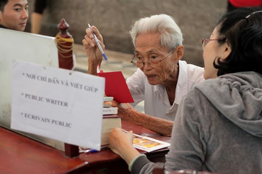 <img src="Mr. Duong-Van-Ngo-was-photographed-while-he-was-still working-at-the-central-post -office-06.jpg" alt="Last public writer at Saigon Central Post Office - Ho Chi Minh tourist Attractions">